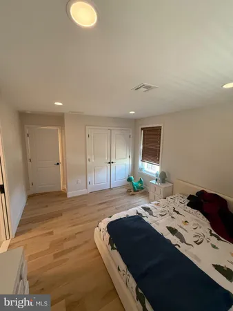 a bedroom with a bed and a television