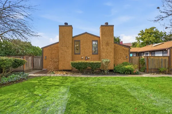 a front view of house with yard and green space