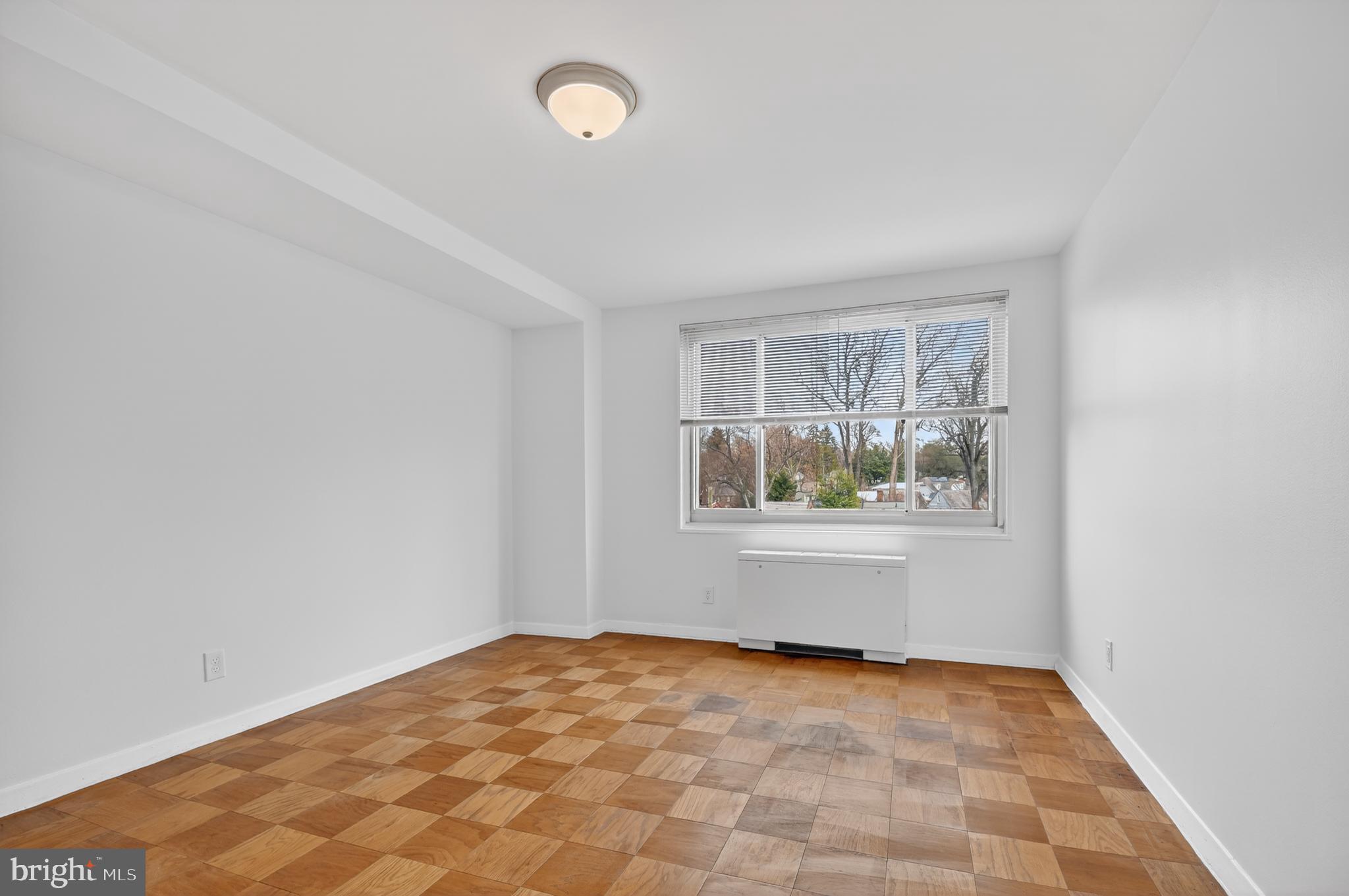 1900 Lyttonsville Road, Unit 718 Silver Spring, MD 20910 - Photo 16 of 35 Primary Bedroom w/ Hardwood Floors & Large Windows