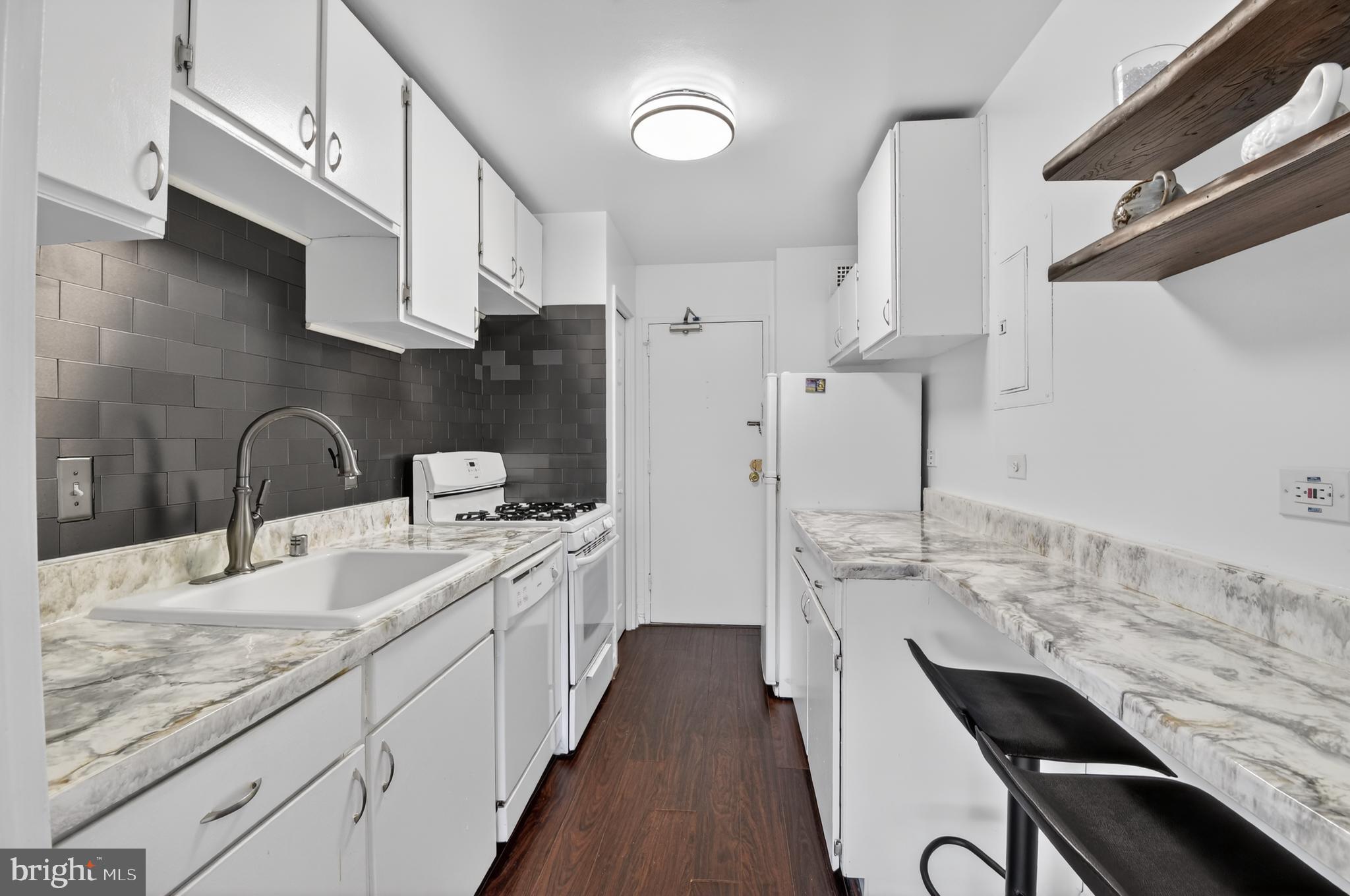 1900 Lyttonsville Road, Unit 718 Silver Spring, MD 20910 - Photo 19 of 35 Kitchen with Bar Seating and Open Shelving