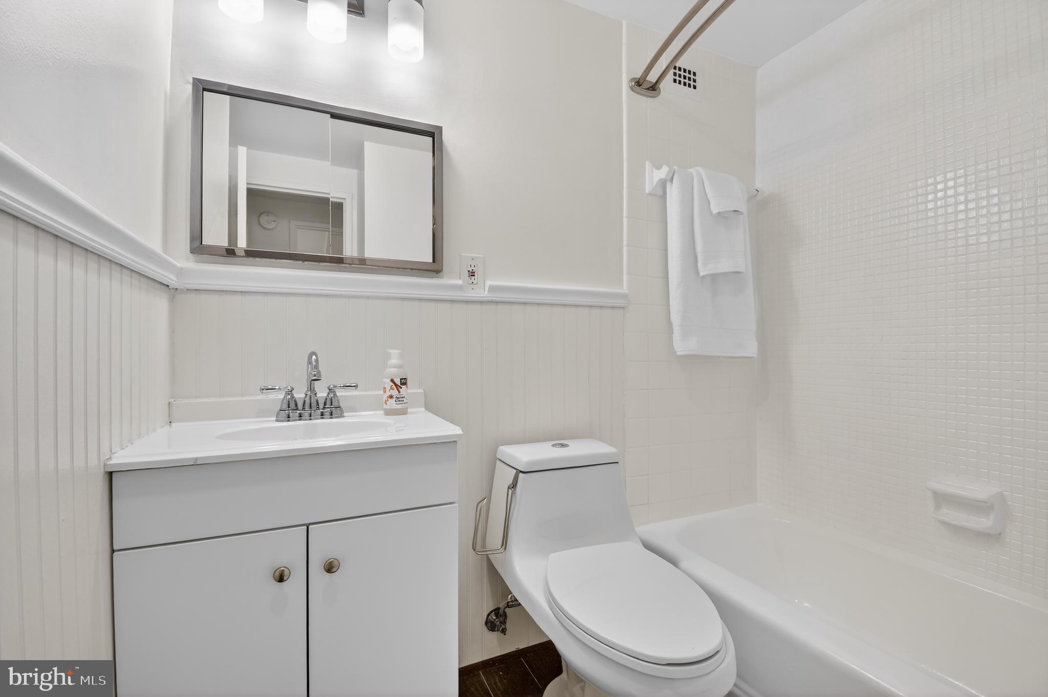 1900 Lyttonsville Road, Unit 718 Silver Spring, MD 20910 - Photo 22 of 35 Bright, White Bathroom with Wainscoting