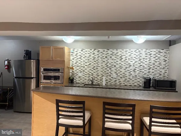 a kitchen with a sink and a refrigerator