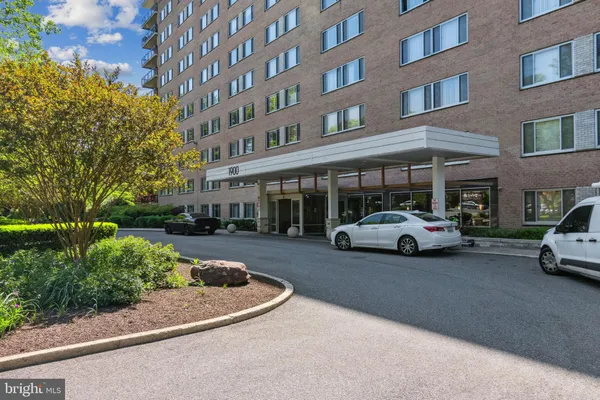 a view of a cars park in front of a building