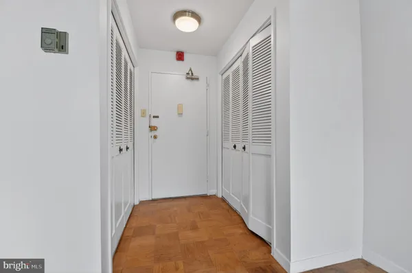 a view of hallway with wooden floor