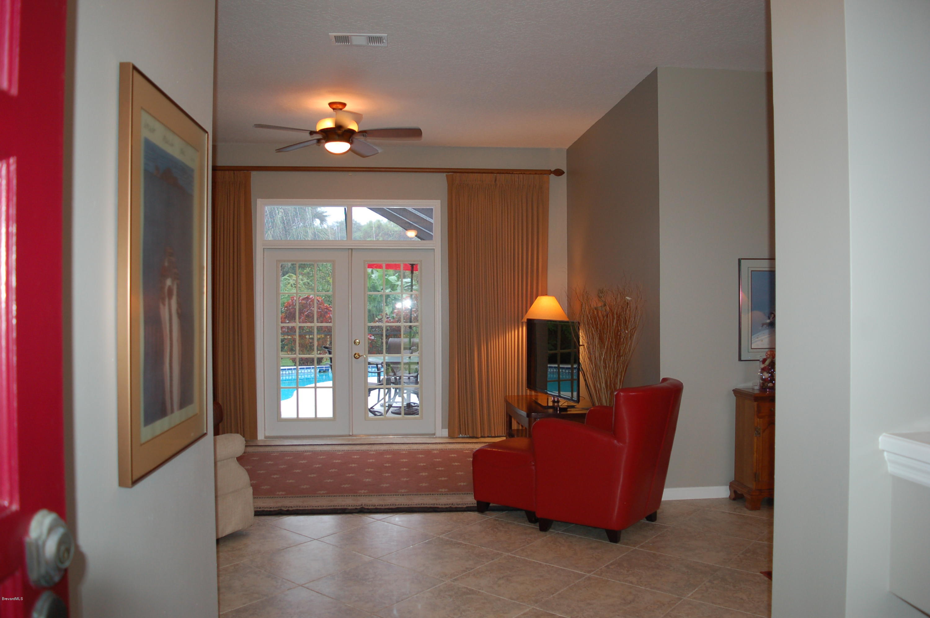 3987 Sparrow Hawk Road Melbourne, FL 32934 - Photo 2 of 21 Front Door Opening to Formal Living Rm
