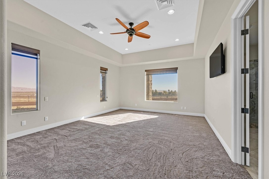 5790 Aspen Falls Circle Las Vegas, NV 89149 - Photo 24 of 61 Carpeted empty room featuring a ceiling fan, recessed lighting, and a tray ceiling