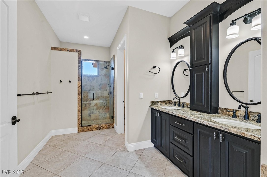 5790 Aspen Falls Circle Las Vegas, NV 89149 - Photo 27 of 61 Full bath with a stall shower, double vanity, and tile patterned flooring