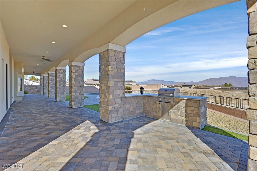 5790 Aspen Falls Circle Las Vegas, NV 89149 - Photo 41 of 61 View of patio with an outdoor kitchen and a mountain view