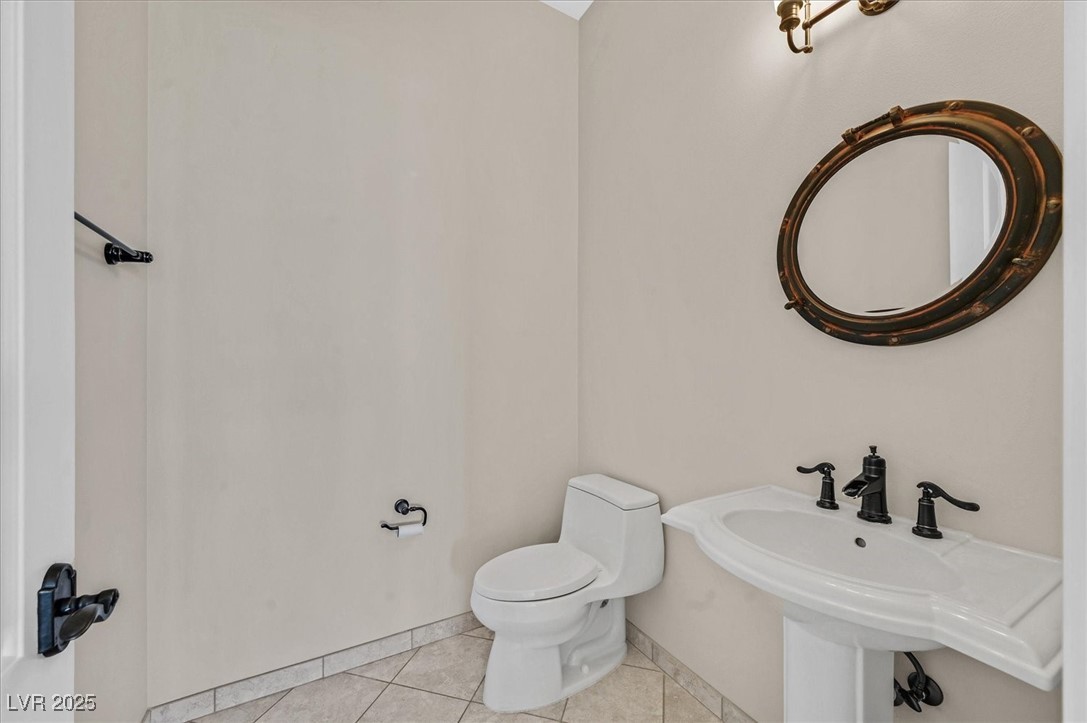 5790 Aspen Falls Circle Las Vegas, NV 89149 - Photo 49 of 61 Half bathroom with toilet and tile patterned floors