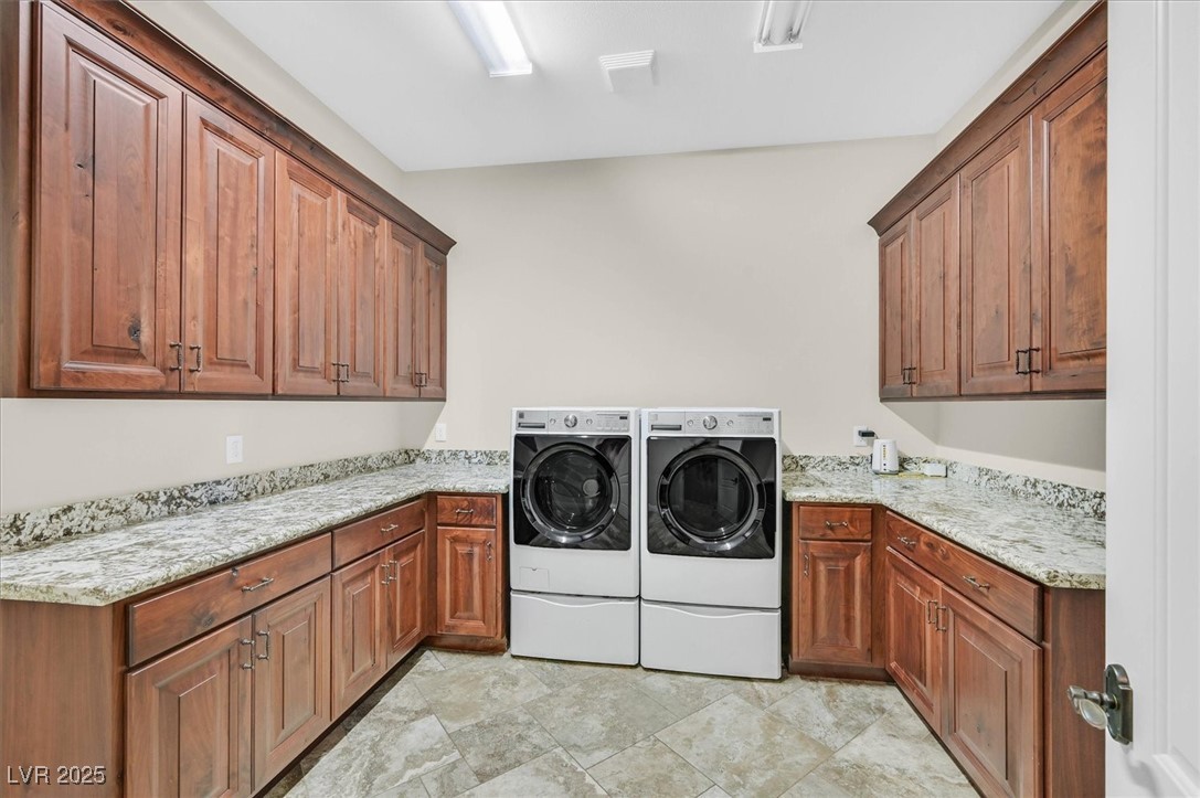 5790 Aspen Falls Circle Las Vegas, NV 89149 - Photo 50 of 61 Laundry room with cabinet space, independent washer and dryer, and stone finish flooring
