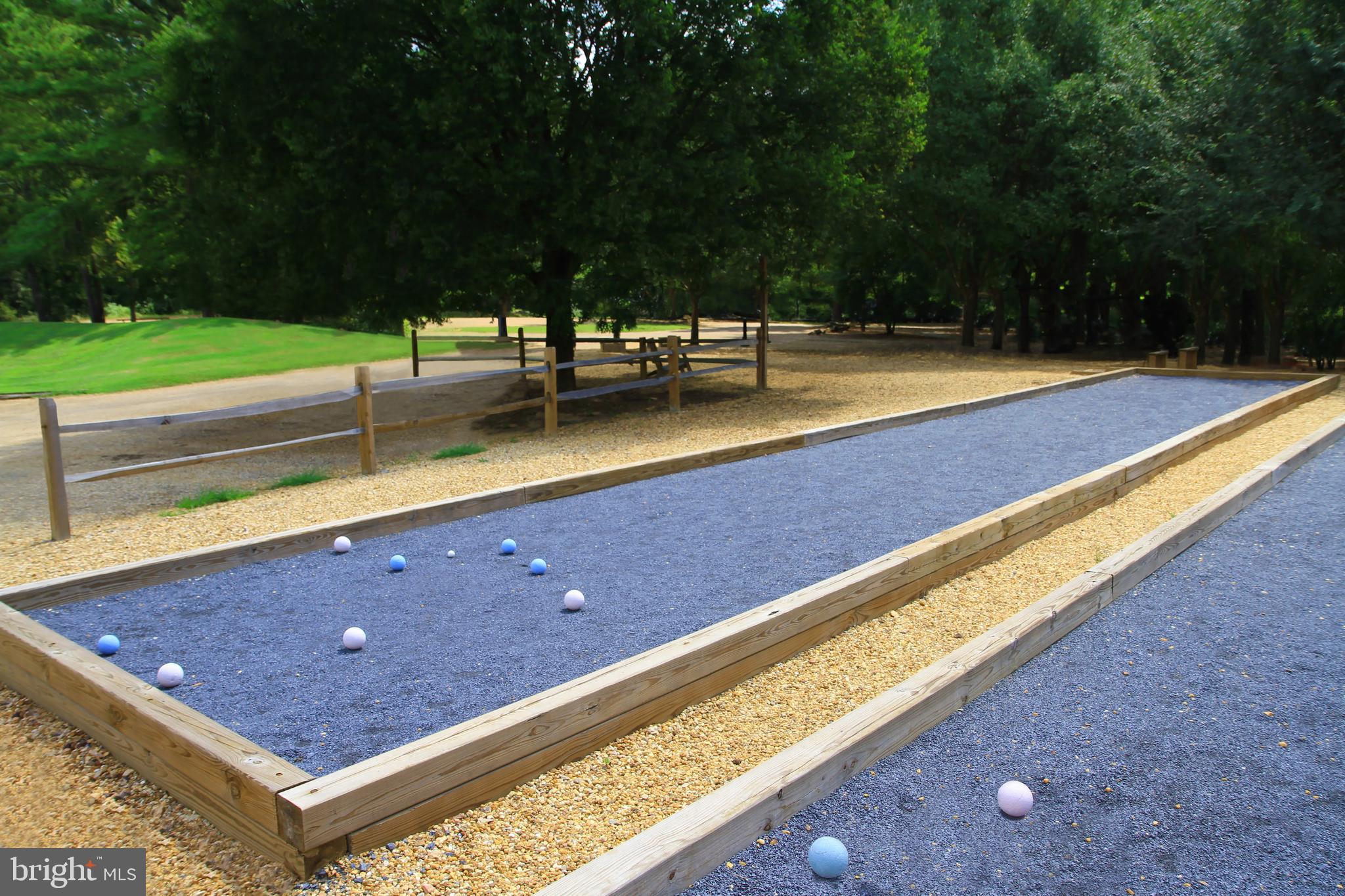 7 Sepia Square, Unit KA Ashburn, VA 20147 - Photo 17 of 19 a view of a tennis court with a bench