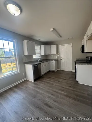 a kitchen with stainless steel appliances granite countertop a stove and a refrigerator