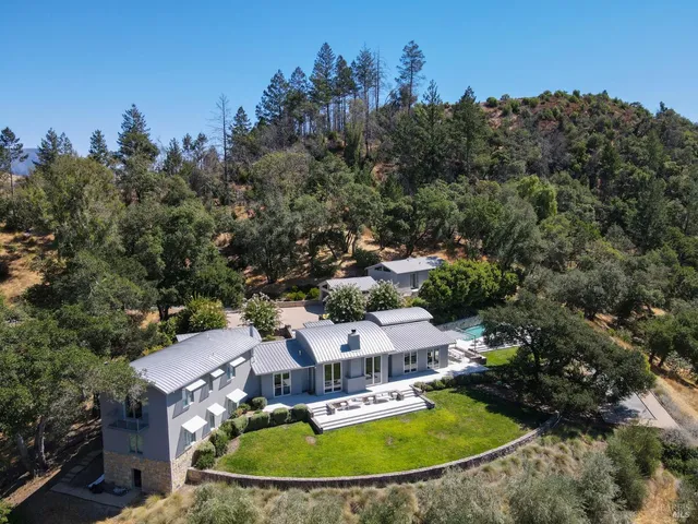 a bedroom with a bed and a lamp on the dresser