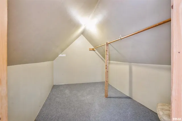 a bathroom with a granite countertop toilet sink and mirror
