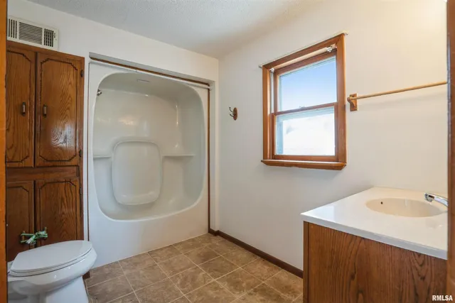 a bathroom with a sink a mirror and a shower