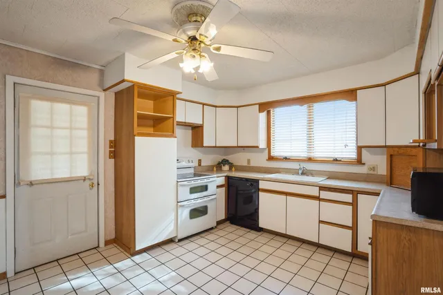 a kitchen with a sink cabinets and window