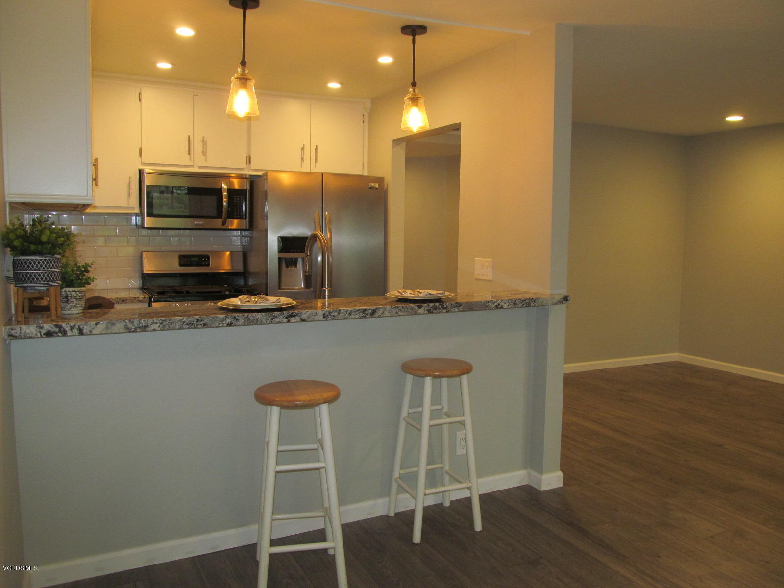 1706 Sinaloa Road, Unit 112 Simi Valley, CA 93065 - Photo 11 of 37 a kitchen with stainless steel appliances granite countertop a kitchen island a stove a cabinets and a sink
