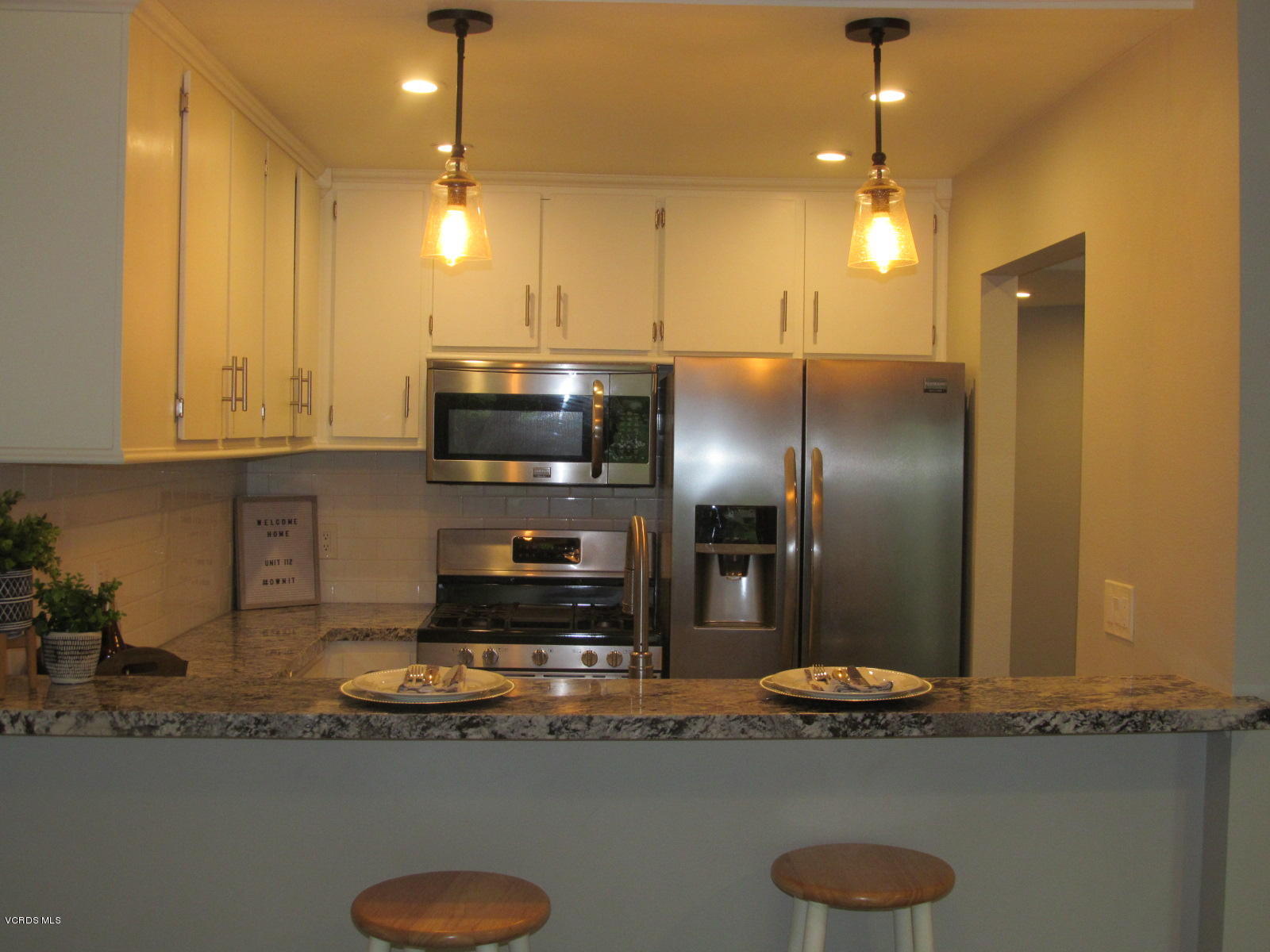 1706 Sinaloa Road, Unit 112 Simi Valley, CA 93065 - Photo 14 of 37 a kitchen with stainless steel appliances granite countertop a sink a stove and a refrigerator