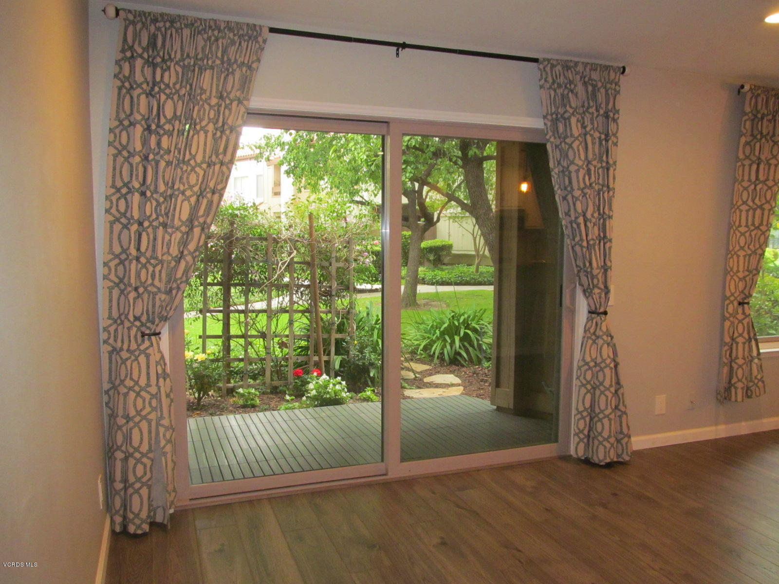 1706 Sinaloa Road, Unit 112 Simi Valley, CA 93065 - Photo 22 of 37 a view of porch with a floor to ceiling window and wooden floor