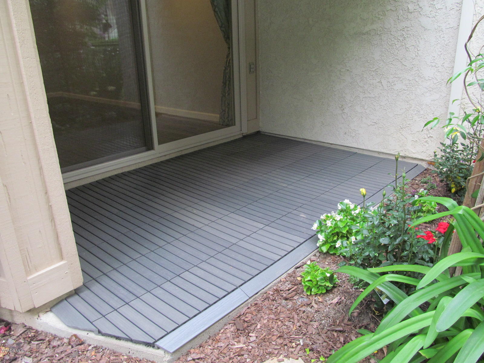 1706 Sinaloa Road, Unit 112 Simi Valley, CA 93065 - Photo 24 of 37 a view of a porch with wooden floor and garden