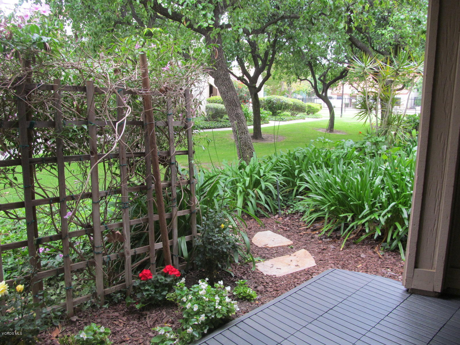 1706 Sinaloa Road, Unit 112 Simi Valley, CA 93065 - Photo 26 of 37 a backyard of a house with lots of green space and plants