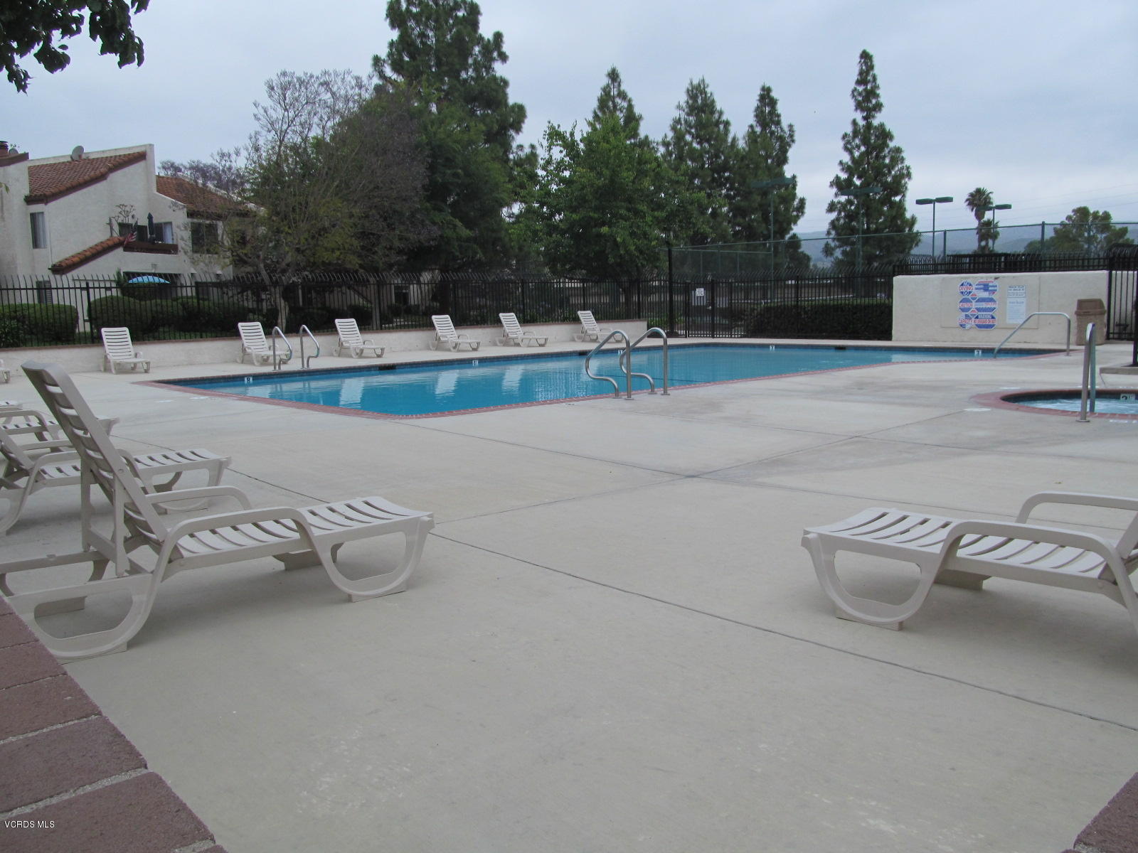 1706 Sinaloa Road, Unit 112 Simi Valley, CA 93065 - Photo 33 of 37 a view of swimming pool with outdoor seating and trees in the background