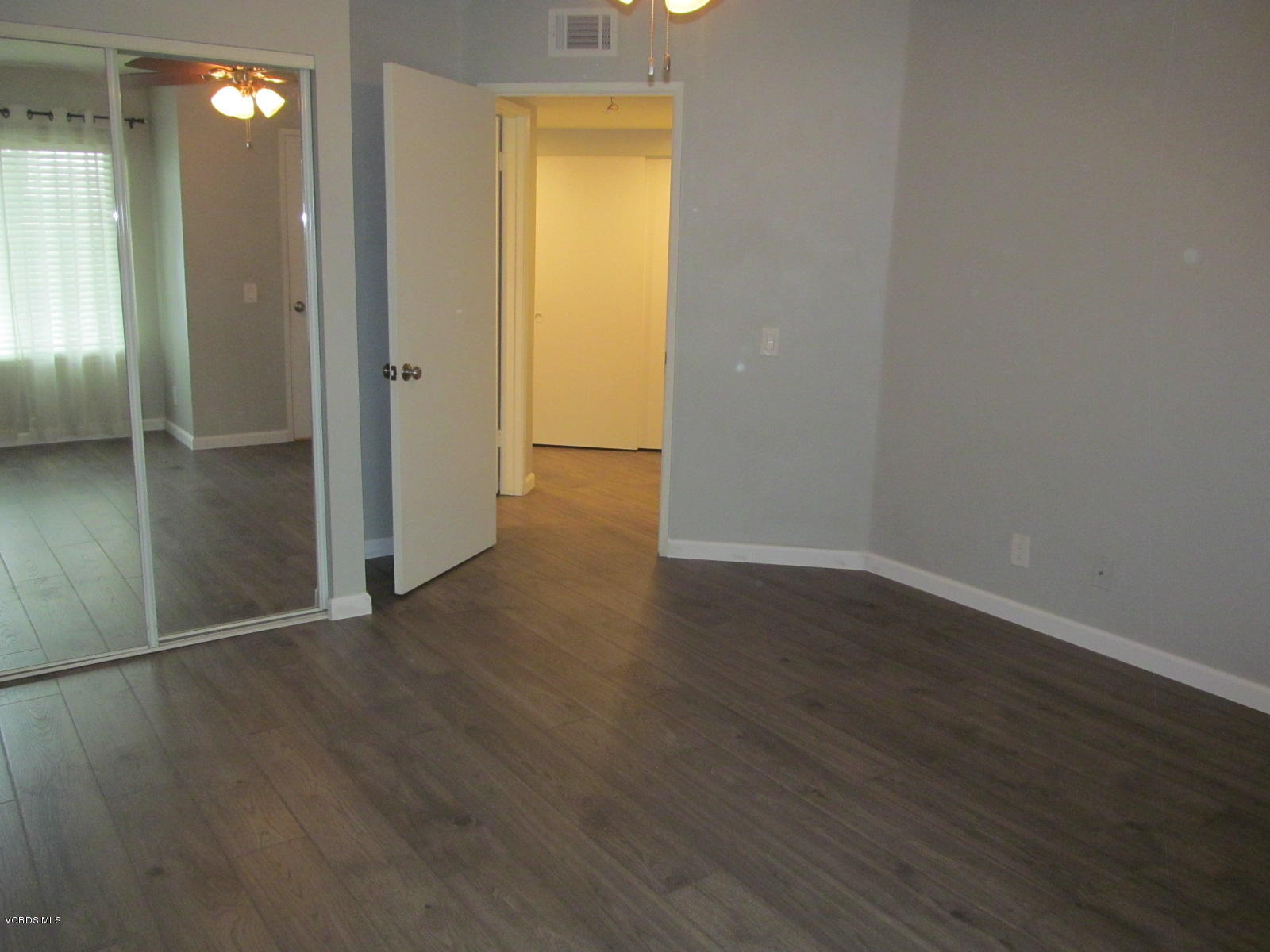 1706 Sinaloa Road, Unit 112 Simi Valley, CA 93065 - Photo 7 of 37 an empty room with wooden floor and closet