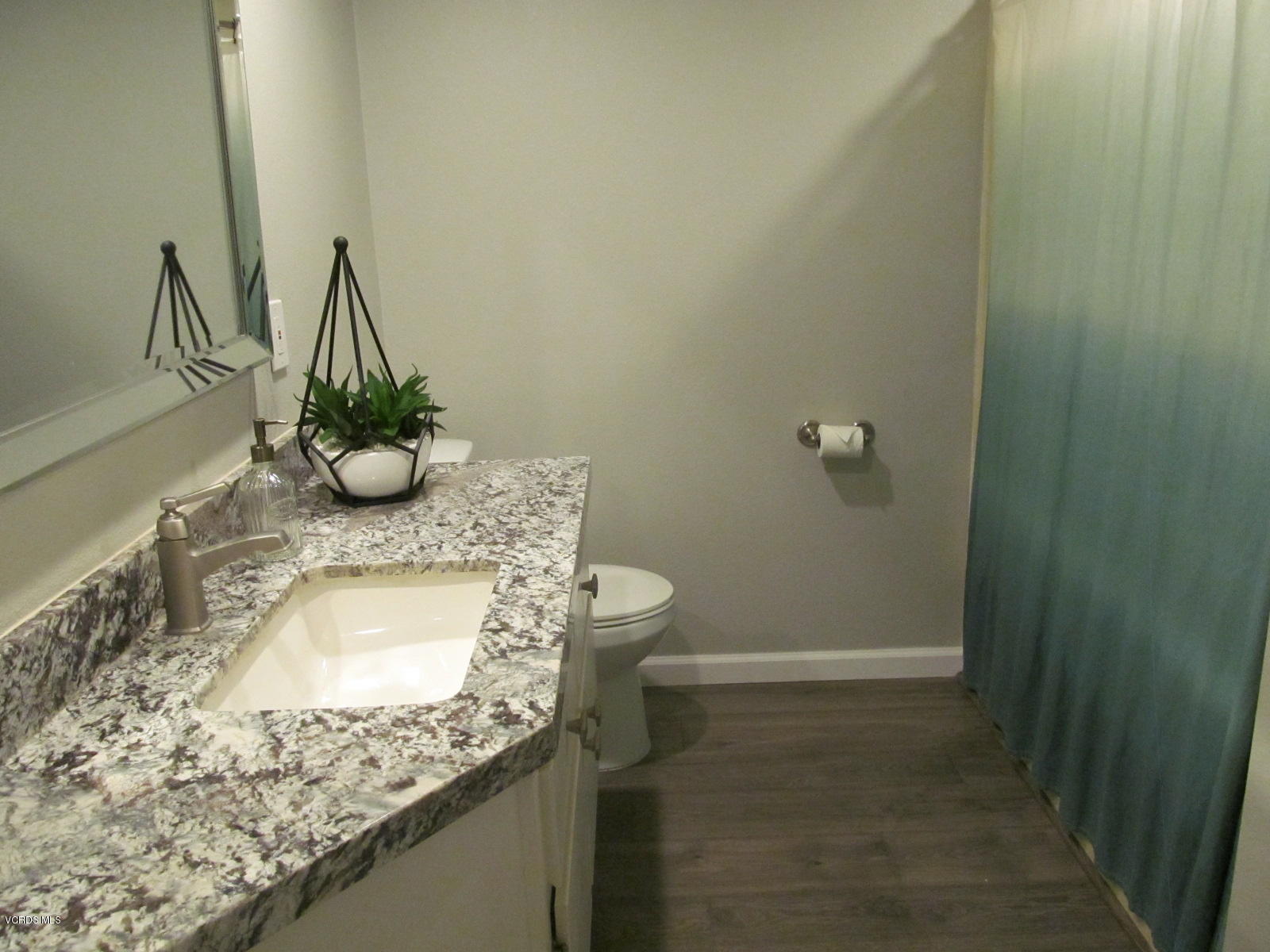 1706 Sinaloa Road, Unit 112 Simi Valley, CA 93065 - Photo 8 of 37 a bathroom with a granite countertop sink and a mirror