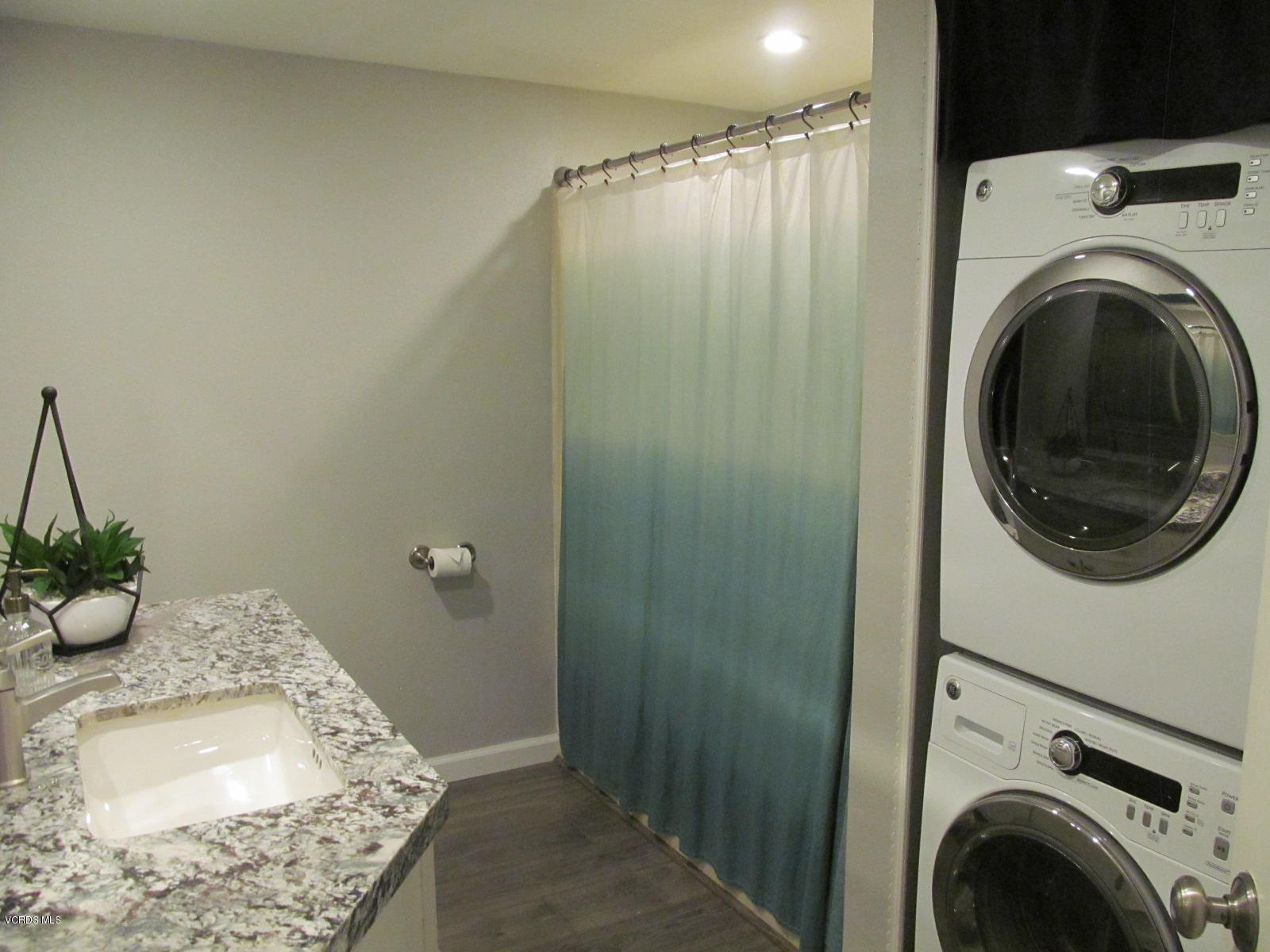 1706 Sinaloa Road, Unit 112 Simi Valley, CA 93065 - Photo 9 of 37 a bathroom with a sink a washer and dryer