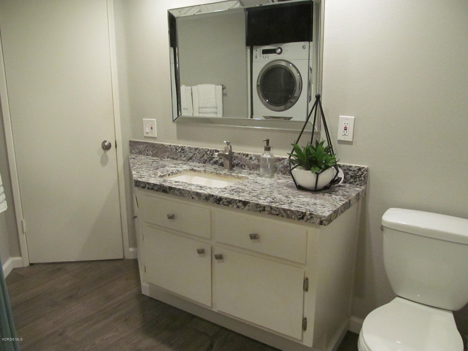 1706 Sinaloa Road, Unit 112 Simi Valley, CA 93065 - Photo 10 of 37 a bathroom with a granite countertop toilet sink and mirror