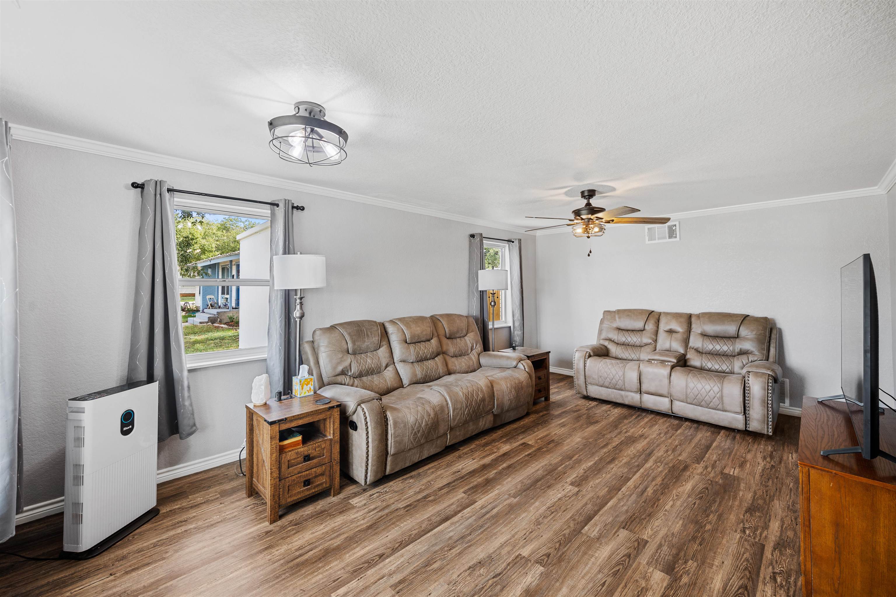 407 Lamon Street Burnet, TX 78611 - Photo 3 of 24 a living room with furniture and a flat screen tv