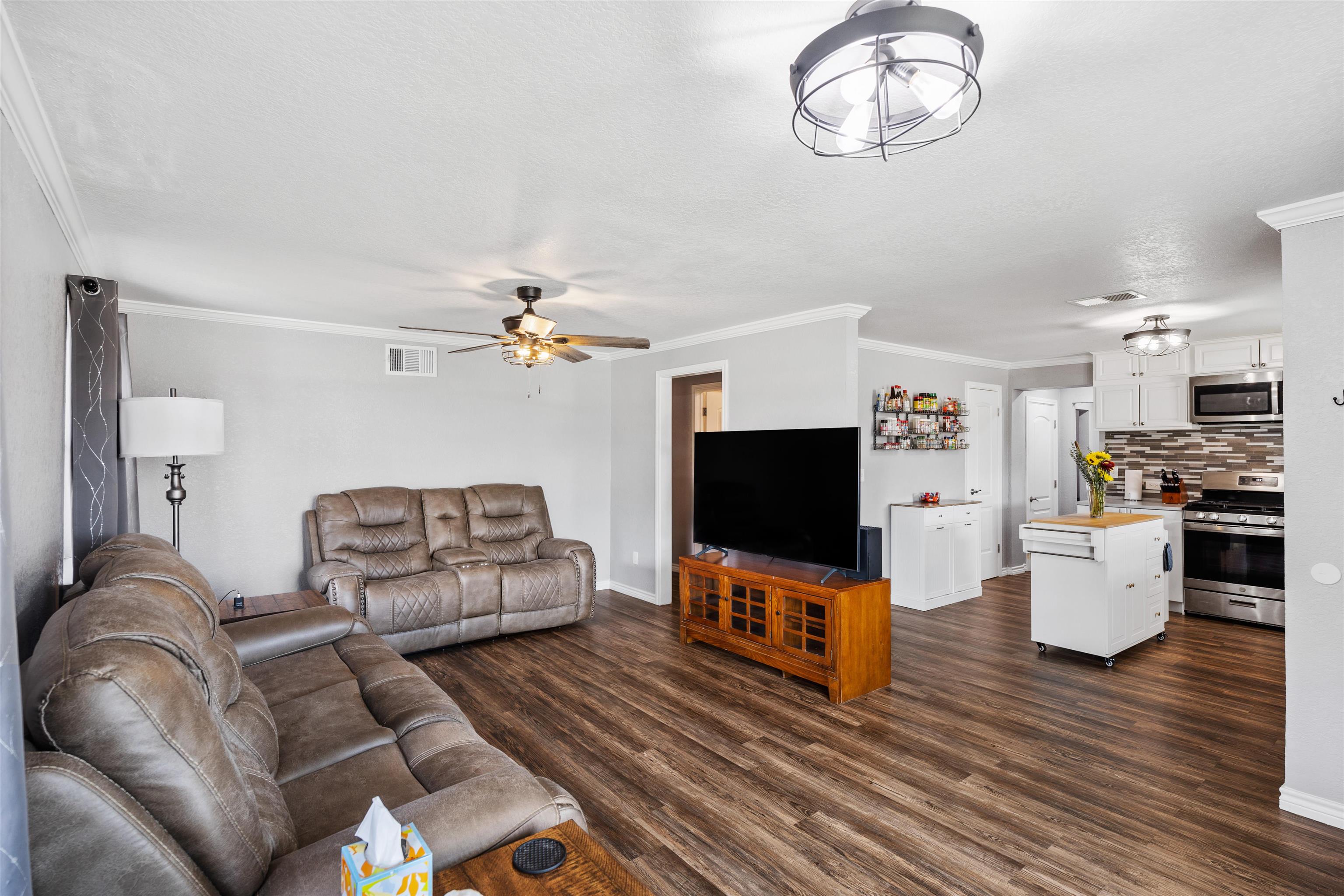 407 Lamon Street Burnet, TX 78611 - Photo 4 of 24 a living room with furniture and a flat screen tv