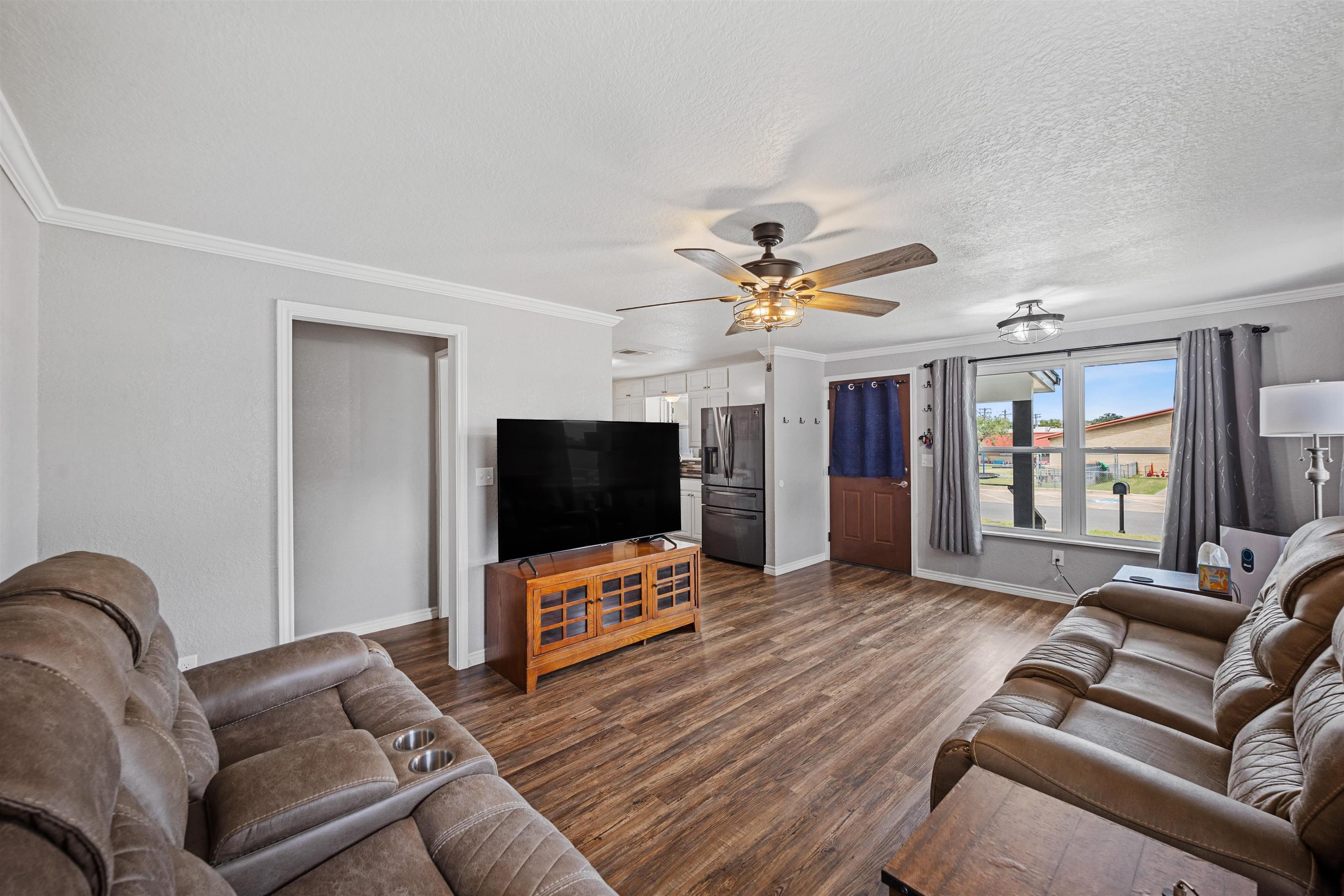 407 Lamon Street Burnet, TX 78611 - Photo 5 of 24 a living room with furniture and a flat screen tv