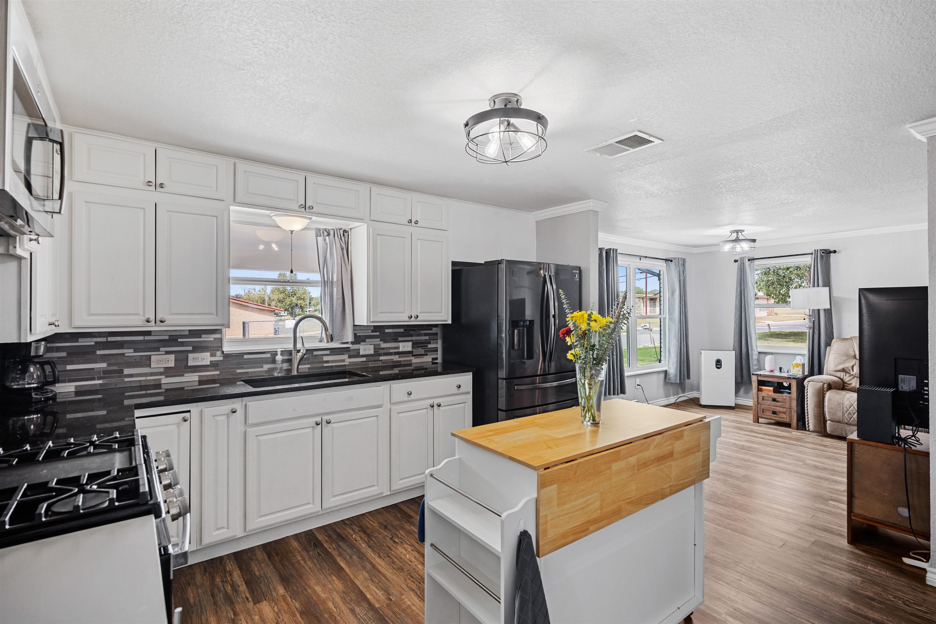 407 Lamon Street Burnet, TX 78611 - Photo 7 of 24 a kitchen with stainless steel appliances a sink stove and refrigerator