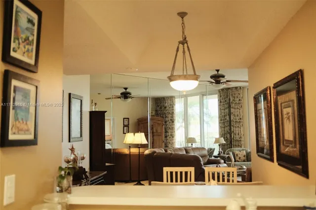 a living room with furniture and floor to ceiling windows
