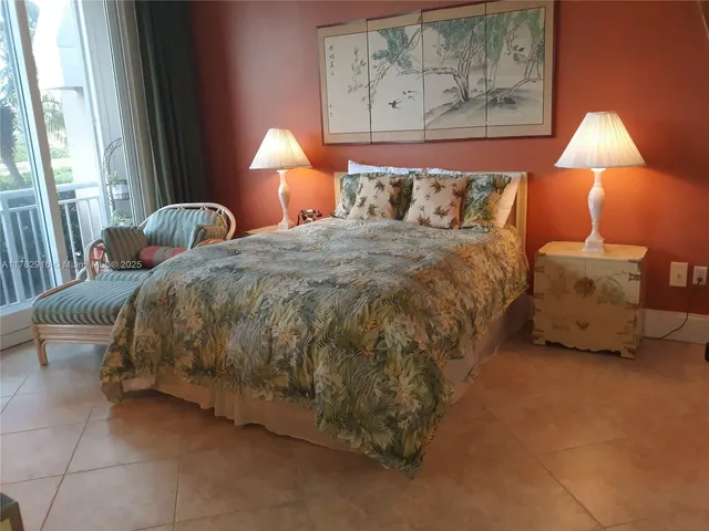 a bed sitting in a bedroom next to a lamp