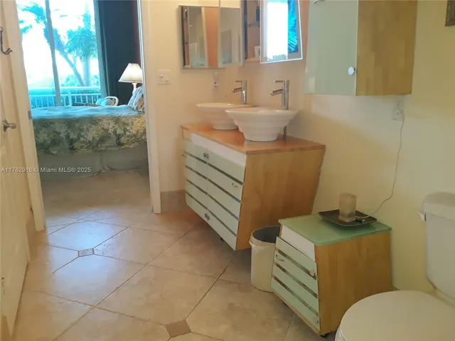 a bathroom with a sink toilet and mirror
