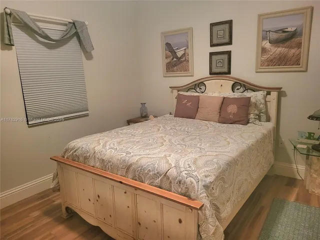 a bedroom with a bed and a dresser in it