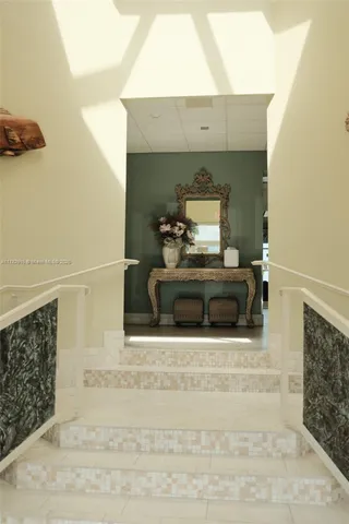 a living room with furniture and a floor to ceiling window