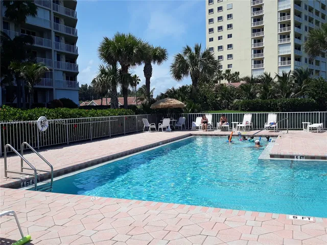 a patio with a table and chairs under an umbrella