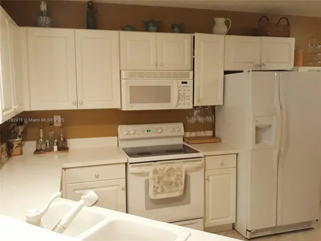 a kitchen with a sink and a refrigerator