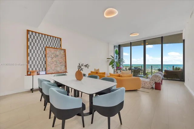 a view of a dining room with furniture large windows and wooden floor