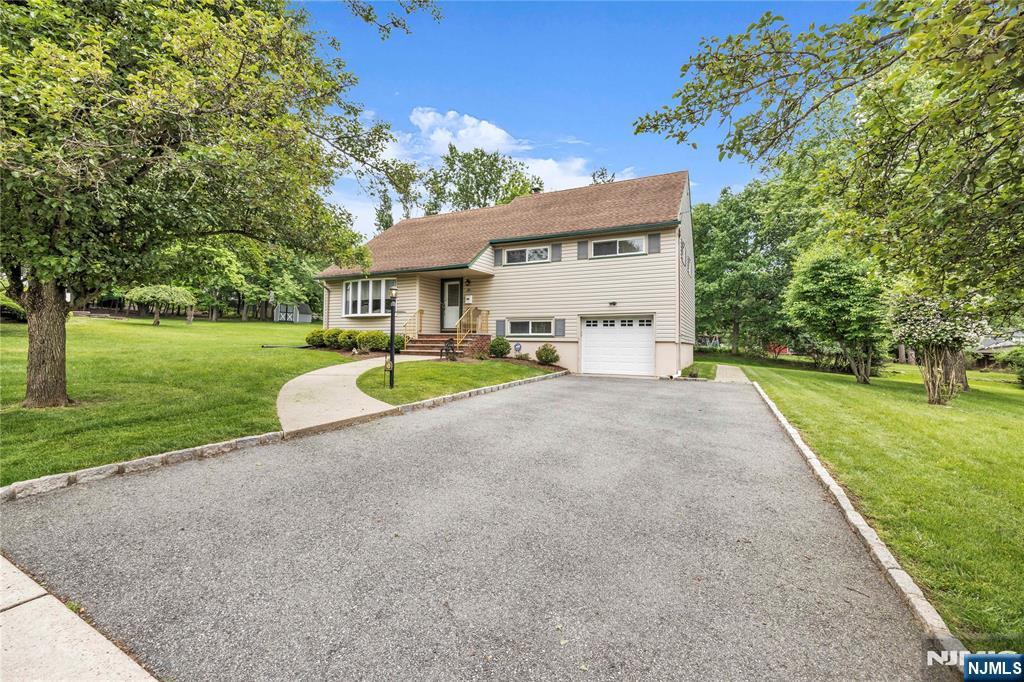 23 Ridge Court Cedar Grove, NJ 07009 - Photo 2 of 37 a view of a house with a big yard and large trees