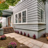 a backyard of a house with fountain table and chairs
