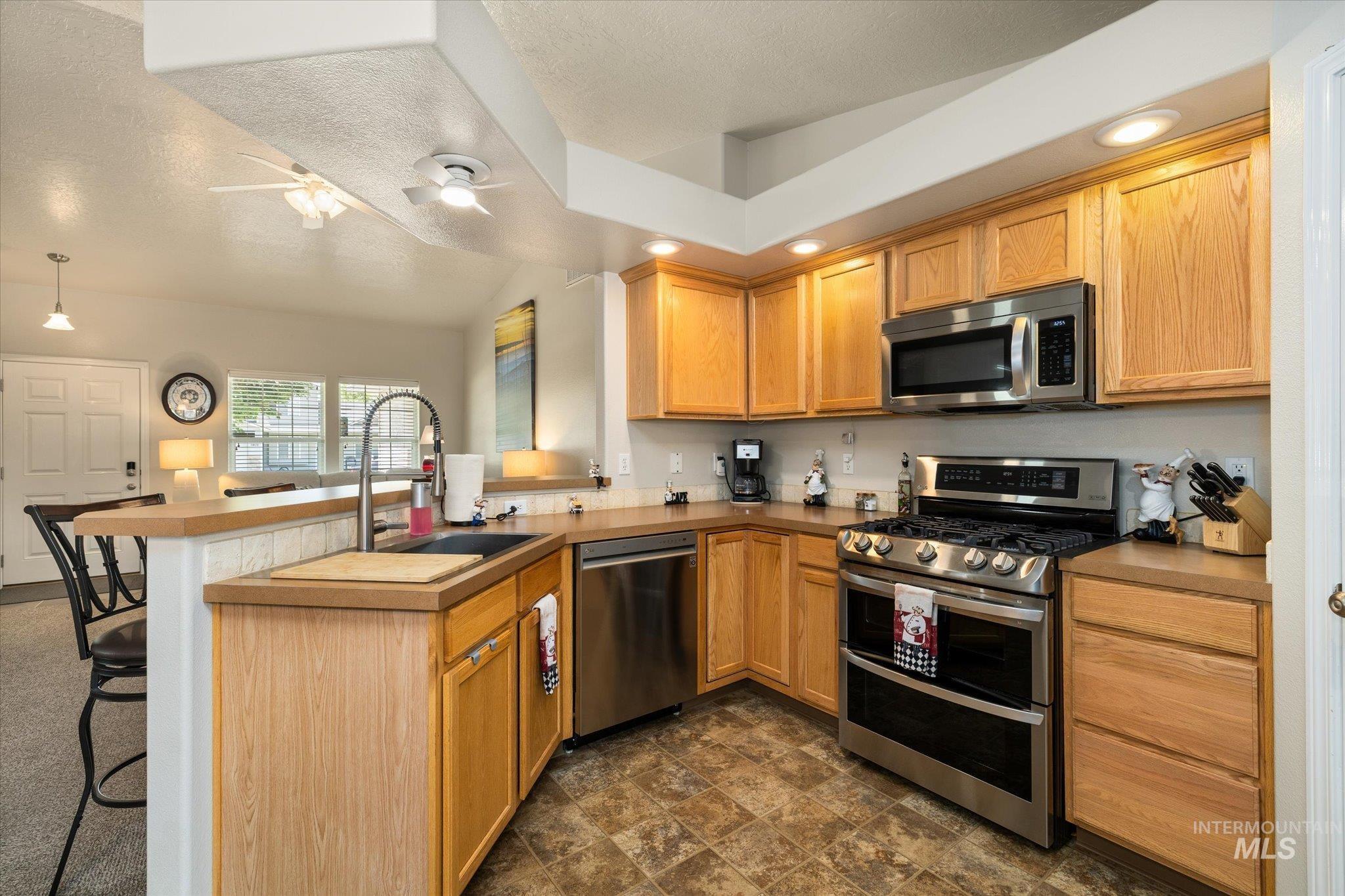 5401 Barkley Way Caldwell, ID 83607 - Photo 22 of 35 Kitchen featuring wood cabinetry, stainless steel appliances, a corner sink with a high-arc faucet, and recessed lighting