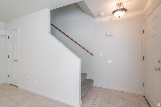 1735 West 540 North, Unit 1805 St. George, UT 84770 - Photo 37 of 64 Entryway featuring a carpeted staircase with wood handrail, tiled flooring, and paneled doors