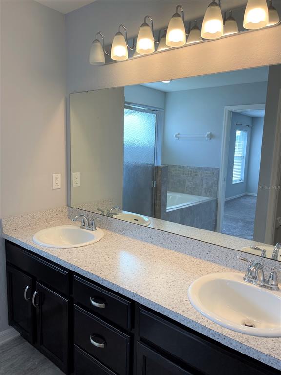 3623 Peregrine Way Lakeland, FL 33811 - Photo 20 of 35 a bathroom with a sink and a mirror