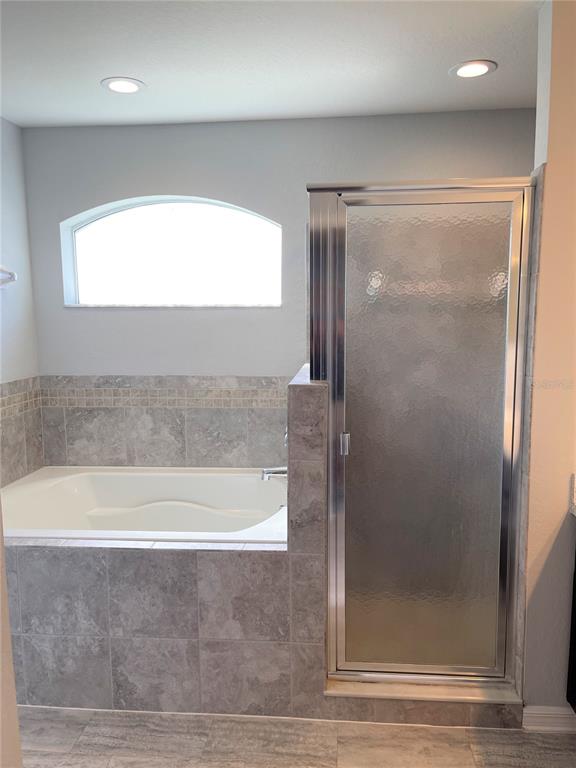 3623 Peregrine Way Lakeland, FL 33811 - Photo 21 of 35 a bathroom with a bathtub and a shower