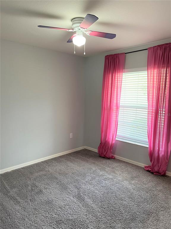 3623 Peregrine Way Lakeland, FL 33811 - Photo 28 of 35 an empty room with windows and fan