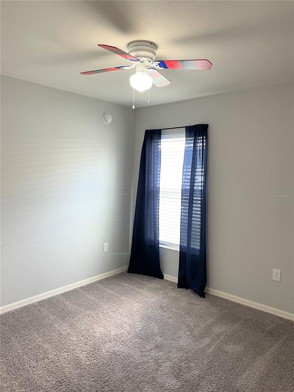 3623 Peregrine Way Lakeland, FL 33811 - Photo 32 of 35 an empty room with windows and fan
